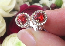 Natural Orange Red Sapphire Stud Earrings with a real diamond halo set in solid 14k white gold