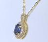 1 carat Oval Blue Sapphire and Diamond Halo Pendant in 14k yellow gold with a 16 inch 14k yellow gold chain