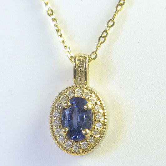 Oval Blue Sapphire and Diamond Pendant in 14k yellow gold with a 16 inch 14k yellow gold chain