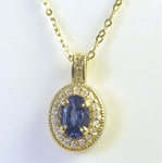 Oval Blue Sapphire and Diamond Pendant in 14k yellow gold with a 16 inch 14k yellow gold chain