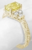 Ornate oval yellow sapphire ring in yellow gold