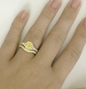 Ornate oval yellow sapphire ring in yellow gold on the hand