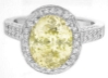 Large Natural oval yellow sapphire diamond halo ring in white gold with milgrain edging