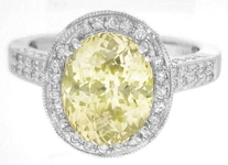 Large oval yellow sapphire diamond halo ring in white gold
