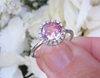 Round Peachy Pink Natural Sapphire Ring with a Diamond Halo in simple white gold band for sale