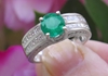 Natural Round Emerald Ring in a 18k white gold and diamond band for sale