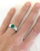 Round Emerald Ring with Princess Cut Channel Set Diamonds in 18k white gold