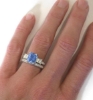 Radiant Blue Sapphire Engagement Ring with Baguette Diamonds on the hand