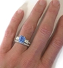 Radiant Blue Sapphire Engagement Ring with Baguette Diamonds on the hand