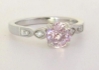 feminine pale pink sapphire and diamond ring in white gold band