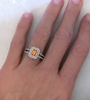 Hand image of Genuine Emerald Cut Orange Sapphire and Diamond Ring in 14k white gold