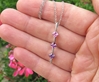 Princess Cut Natural Pink and Natural Purple Stick Pendant in 14k white gold. 3 Stone Pendant