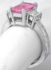 Profile View of Sleek Channel Set Baguette Diamond Ring with Prong Set Large Baguette Diamonds and Radiant Cut Pink Sapphire