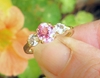 Natural Oval Pink Sapphire Three Stone Ring with white sapphires in 14k yellow gold for sale