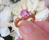 Real Rose Gold Natural Cushion Pink Sapphire Wedding Ring with Round Side Diamonds with an ornate scroll pattern band