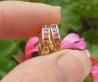 Natural Rainbow Sapphire Huggie Hoop Earrings in 14k yellow gold. Round Sapphires