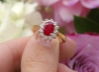 Genuine Oval Ruby Engagement Ring with Natural Diamond Halo set in a solid 14k yellow gold and white gold band
