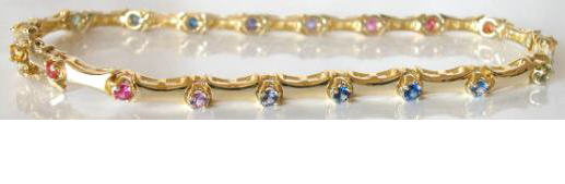Round cut natural rainbow sapphire bracelet set in solid 14k yellow gold for sale. LGBT.