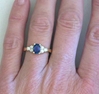 Dark blue natural sapphire ring with side diamonds in 14k yellow gold