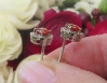 Natural Orange Red Sapphire Stud Earrings with a real diamond halo set in solid 14k white gold