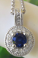 Royal Blue Natural Sapphire Pendant with a Diamond Halo in solid 14k white gold for sale
