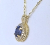 Oval Blue Sapphire and Diamond Pendant in 14k yellow gold with a 16 inch 14k yellow gold chain