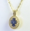 Oval Blue Sapphire and Diamond Pendant in 14k yellow gold with a 16 inch 14k yellow gold chain