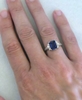 Emerald Cut Blue Sapphire Ring on the hand