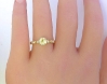 Delicate yellow gold ring featuring natural yellow sapphire center stone