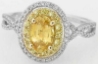 Halo set natural yellow sapphire engagement ring in 14k white and yellow gold